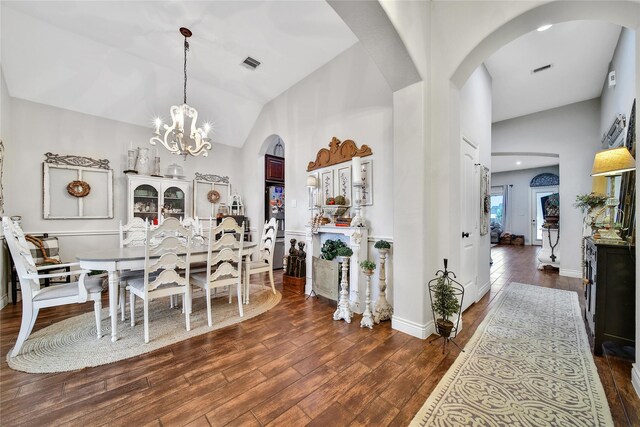 6507 Crystal Forest Trl, Katy, TX 77493 - dining room featuring arched walkways, dark wood-style flooring, a chandelier, and high vaulted ceiling