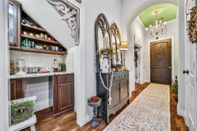 6507 Crystal Forest Trl, Katy, TX 77493 - foyer with a chandelier, arched walkways, dark wood finished floors, and crown molding
