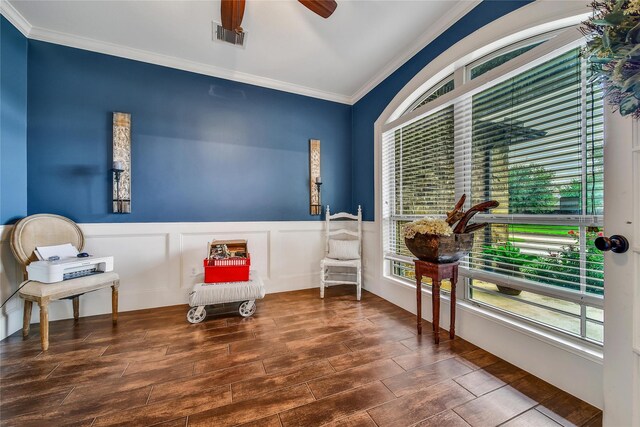 6507 Crystal Forest Trl, Katy, TX 77493 - living area with crown molding, wood finished floors, a wainscoted wall, and a ceiling fan