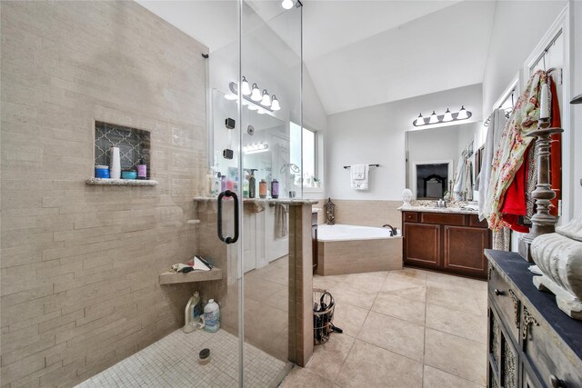 6507 Crystal Forest Trl, Katy, TX 77493 - bathroom with lofted ceiling, tile patterned floors, vanity, a bath, and a stall shower