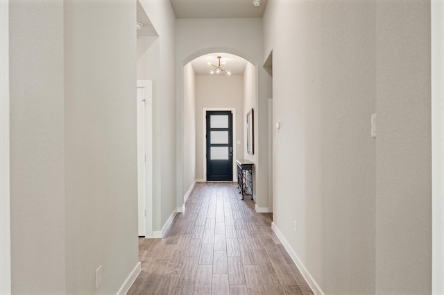 20923 Bradley Gardens Dr, Spring, TX 77379 - corridor with arched walkways and wood finished floors