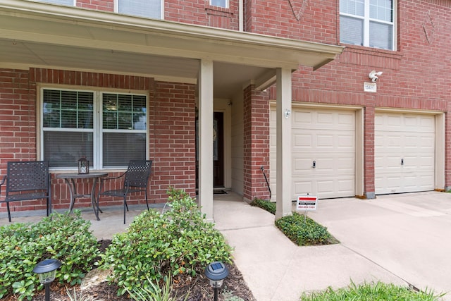 13411 Naples Bridge Rd, Sugar Land, TX 77498 - property entrance with brick siding, driveway, a garage, and covered porch