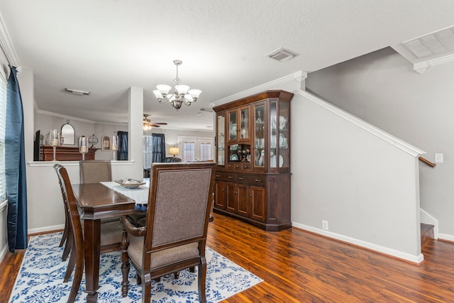 13411 Naples Bridge Rd, Sugar Land, TX 77498 - dining space featuring a chandelier, stairs, dark wood-style flooring, ceiling fan, and ornamental molding