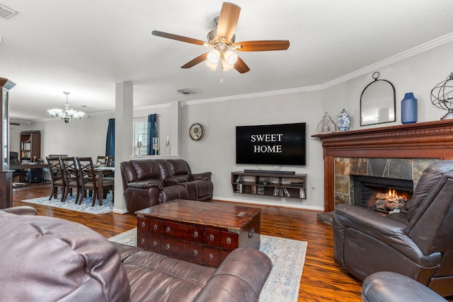 13411 Naples Bridge Rd, Sugar Land, TX 77498 - living room featuring ornamental molding, ceiling fan, a chandelier, wood finished floors, and a tiled fireplace