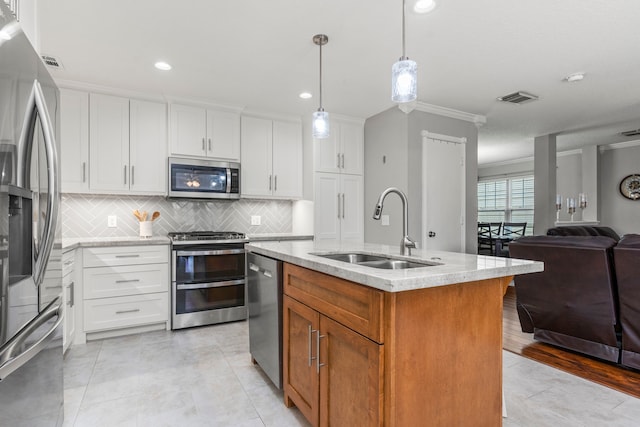 13411 Naples Bridge Rd, Sugar Land, TX 77498 - kitchen featuring stainless steel appliances, open floor plan, light stone countertops, tasteful backsplash, and crown molding