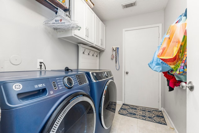 13411 Naples Bridge Rd, Sugar Land, TX 77498 - laundry room featuring washing machine and dryer, cabinet space, and tile patterned floors