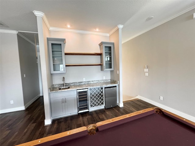 14912 Diamondhead Rd, Conroe, TX 77356 - kitchen with beverage cooler, refrigerator, dark wood-style flooring, gray cabinets, and glass insert cabinets