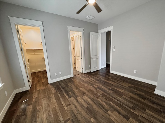 14912 Diamondhead Rd, Conroe, TX 77356 - unfurnished bedroom with dark wood finished floors, a walk in closet, a ceiling fan, and a closet