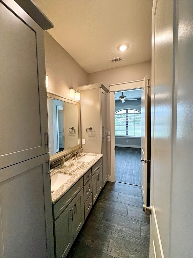 14912 Diamondhead Rd, Conroe, TX 77356 - bathroom featuring double vanity and a ceiling fan