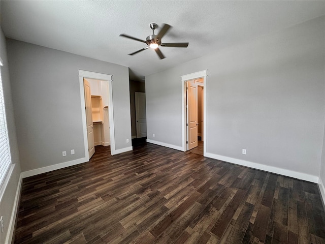 14912 Diamondhead Rd, Conroe, TX 77356 - unfurnished bedroom with dark wood-style floors, a spacious closet, a closet, a ceiling fan, and ensuite bath