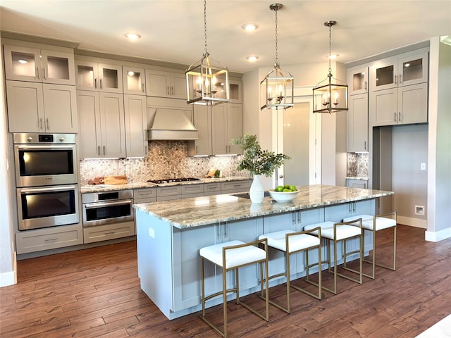 14912 Diamondhead Rd, Conroe, TX 77356 - kitchen with appliances with stainless steel finishes, a chandelier, a kitchen island, premium range hood, and recessed lighting