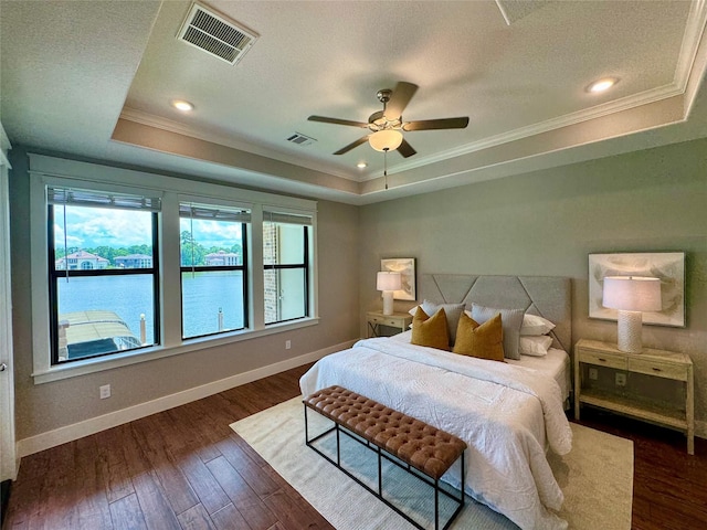 14912 Diamondhead Rd, Conroe, TX 77356 - bedroom featuring a raised ceiling, ornamental molding, dark wood finished floors, a textured ceiling, and ceiling fan