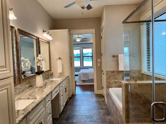 14912 Diamondhead Rd, Conroe, TX 77356 - bathroom featuring a ceiling fan, ensuite bath, double vanity, a bath, and stone tile floors