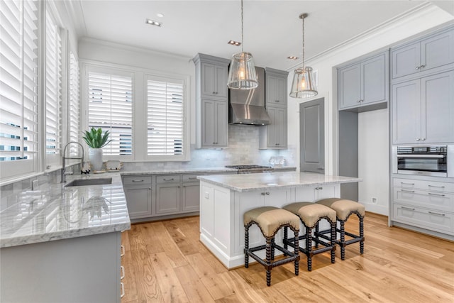 5219 Calle Cordoba Pl, Houston, TX 77007 - kitchen featuring gray cabinets, ornamental molding, light wood-style flooring, decorative backsplash, and light stone countertops