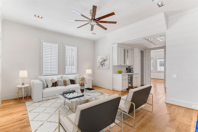 5219 Calle Cordoba Pl, Houston, TX 77007 - living room featuring ceiling fan, ornamental molding, wine cooler, and light wood-style flooring