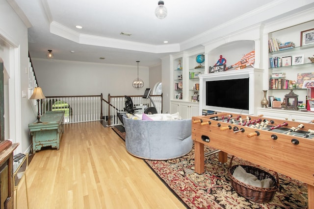 4925 Pine St, Bellaire, TX 77401 - living area featuring light wood finished floors, crown molding, and built in shelves