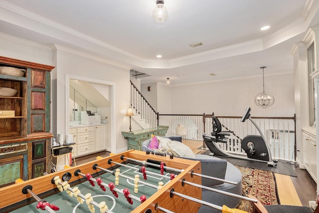 4925 Pine St, Bellaire, TX 77401 - playroom with wood finished floors, crown molding, a chandelier, and a raised ceiling
