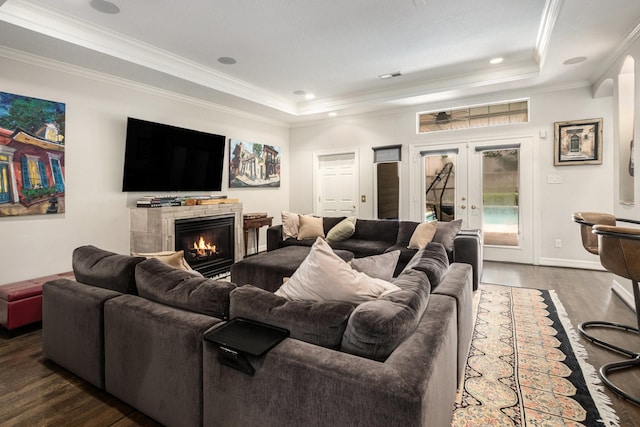 4925 Pine St, Bellaire, TX 77401 - living area with a tray ceiling, dark wood-type flooring, crown molding, french doors, and a warm lit fireplace