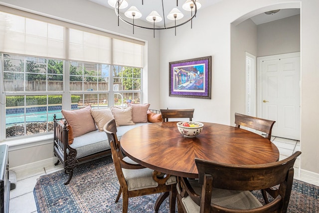 4925 Pine St, Bellaire, TX 77401 - dining area featuring arched walkways and light tile patterned floors
