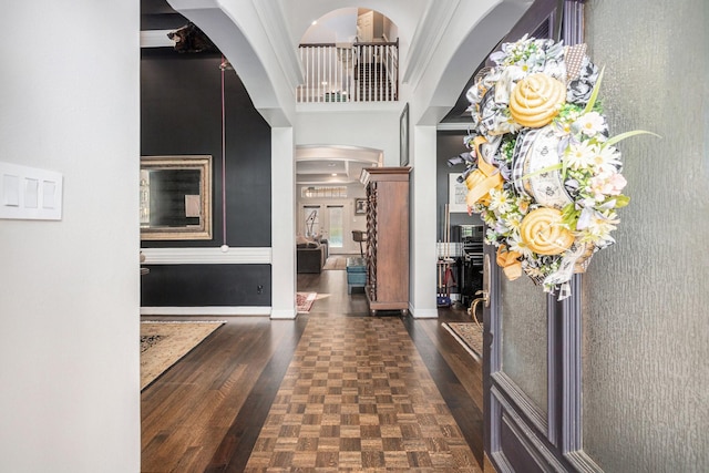 4925 Pine St, Bellaire, TX 77401 - foyer featuring parquet flooring, arched walkways, and a towering ceiling