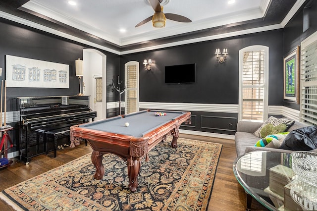 4925 Pine St, Bellaire, TX 77401 - recreation room featuring crown molding, a raised ceiling, arched walkways, a ceiling fan, and wood finished floors