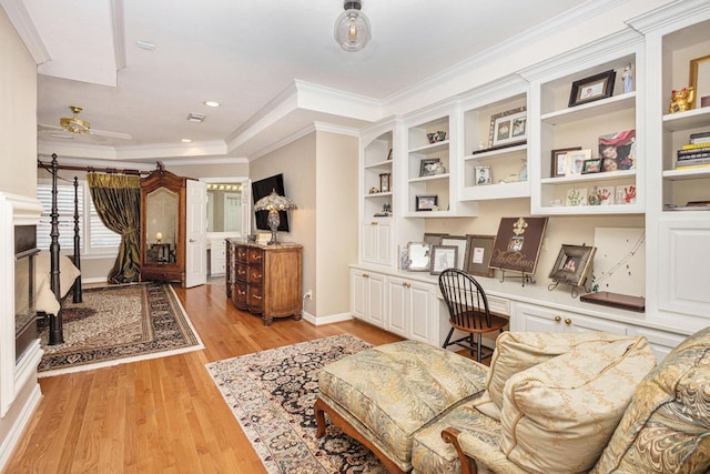 4925 Pine St, Bellaire, TX 77401 - sitting room featuring built in study area, light wood finished floors, ceiling fan, ornamental molding, and recessed lighting