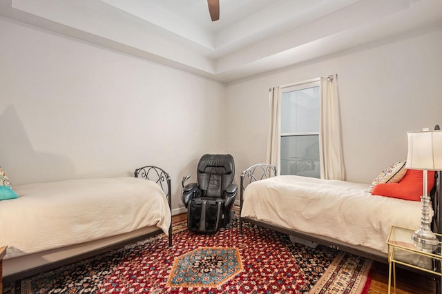 4925 Pine St, Bellaire, TX 77401 - bedroom with a raised ceiling, wood finished floors, and a ceiling fan