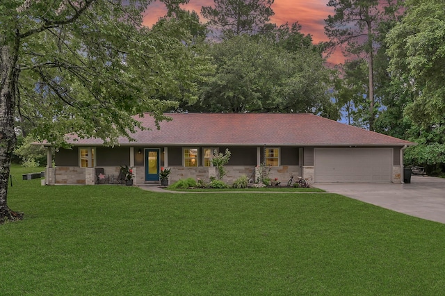 12626 Woodcreek Dr, Willis, TX 77318 - single story home featuring stone siding, a yard, driveway, covered porch, and an attached garage