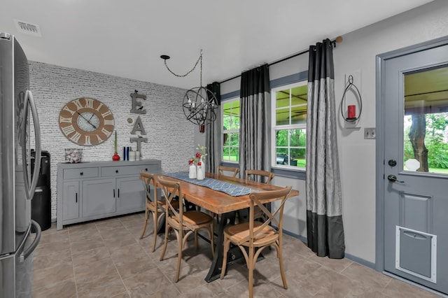 12626 Woodcreek Dr, Willis, TX 77318 - dining space featuring light tile patterned floors and a chandelier