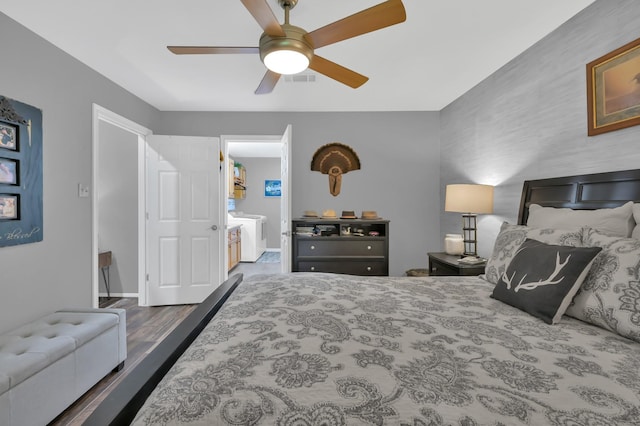 12626 Woodcreek Dr, Willis, TX 77318 - bedroom featuring wood finished floors, ceiling fan, and washing machine and dryer