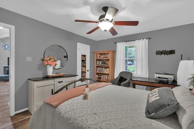 12626 Woodcreek Dr, Willis, TX 77318 - bedroom featuring wood finished floors and a ceiling fan