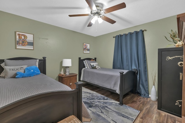 12626 Woodcreek Dr, Willis, TX 77318 - bedroom with wood finished floors and ceiling fan