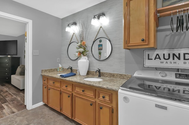 12626 Woodcreek Dr, Willis, TX 77318 - bathroom featuring washer / clothes dryer and vanity