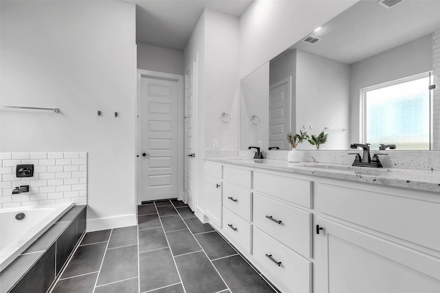 9219 Trimble Landing Dr, Tomball, TX 77375 - full bath with double vanity, a garden tub, and tile patterned floors
