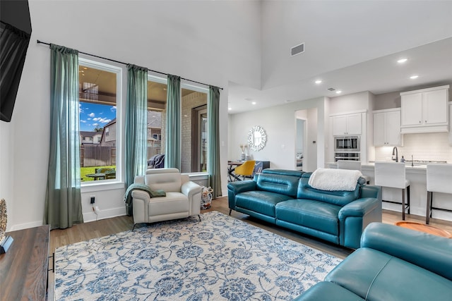 9219 Trimble Landing Dr, Tomball, TX 77375 - living room with wood finished floors, recessed lighting, and a high ceiling