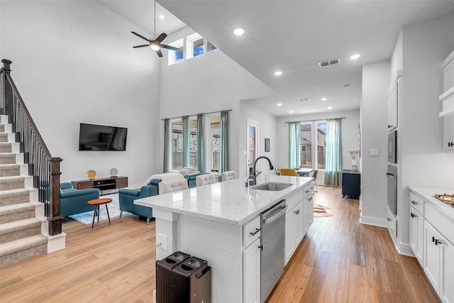 9219 Trimble Landing Dr, Tomball, TX 77375 - kitchen featuring appliances with stainless steel finishes, light wood finished floors, healthy amount of natural light, a ceiling fan, and recessed lighting