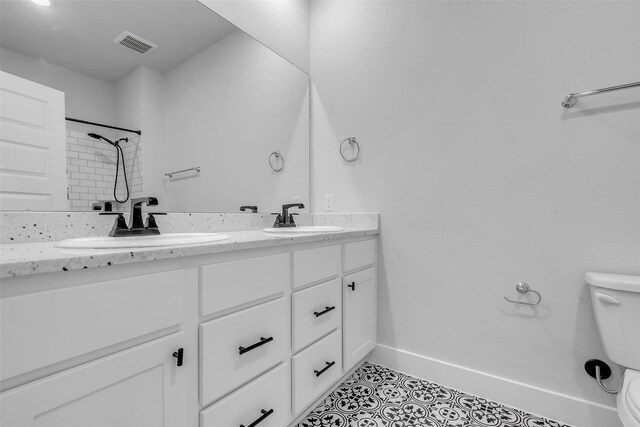 9219 Trimble Landing Dr, Tomball, TX 77375 - bathroom featuring double vanity, tile patterned flooring, and a shower