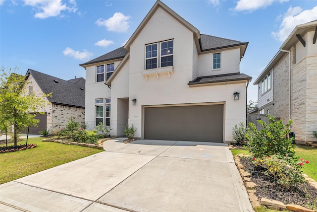 9219 Trimble Landing Dr, Tomball, TX 77375 - view of front of property featuring a garage, stucco siding, a shingled roof, and driveway