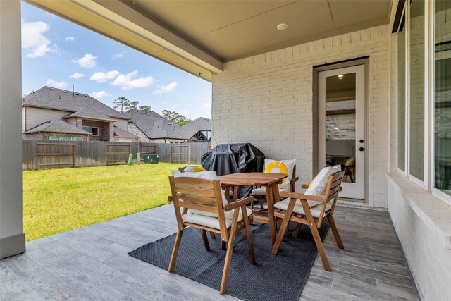 9219 Trimble Landing Dr, Tomball, TX 77375 - fenced backyard with a grill, a patio, and outdoor dining space