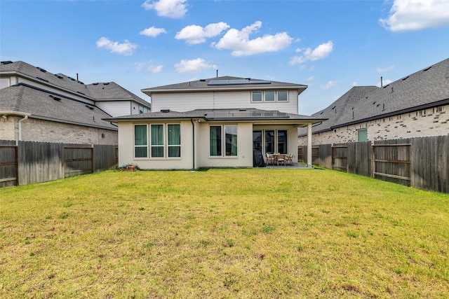 9219 Trimble Landing Dr, Tomball, TX 77375 - back of house featuring a fenced backyard, a patio area, roof mounted solar panels, and roof with shingles