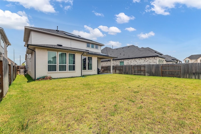 9219 Trimble Landing Dr, Tomball, TX 77375 - back of property with a fenced backyard, solar panels, and brick siding