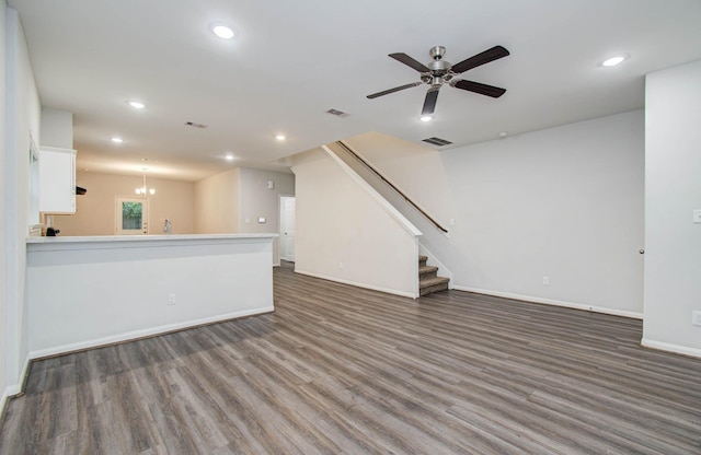 8718 Scott St Unit A B, Houston, TX 77051 - unfurnished living room with wood finished floors, recessed lighting, ceiling fan, stairs, and a chandelier