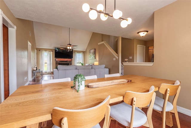 1417 S Heron Dr, Seabrook, TX 77586 - dining space with ceiling fan, wood finished floors, lofted ceiling, a textured ceiling, and stairs