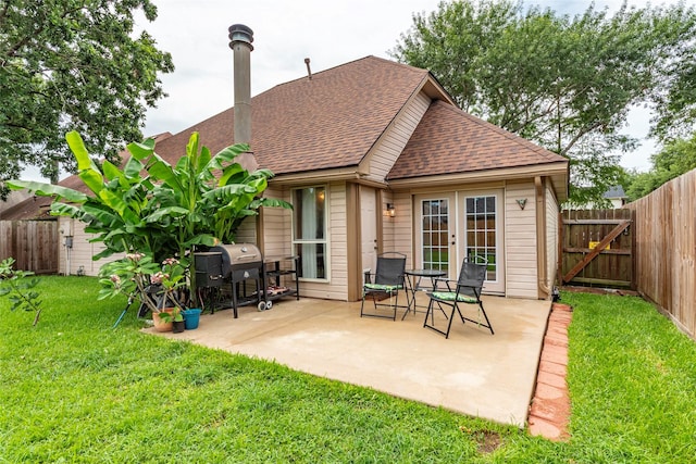 1417 S Heron Dr, Seabrook, TX 77586 - back of property featuring french doors, a shingled roof, a patio, and a fenced backyard