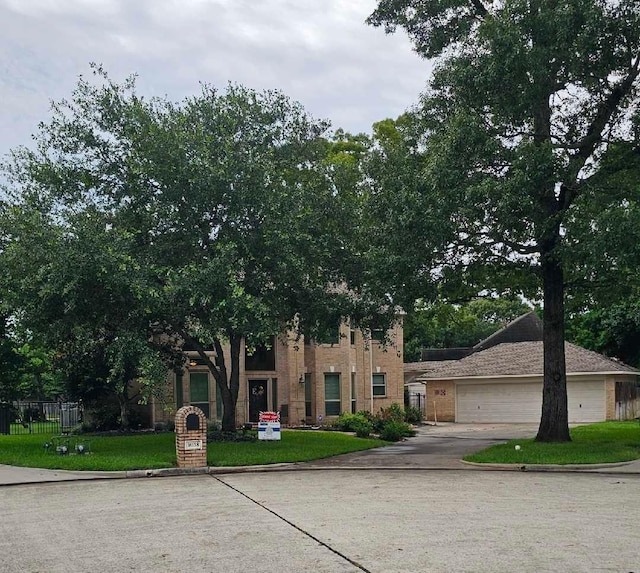 14138 Pollux Ct, Tomball, TX 77375 - view of property hidden behind natural elements featuring concrete driveway, an attached garage, and brick siding