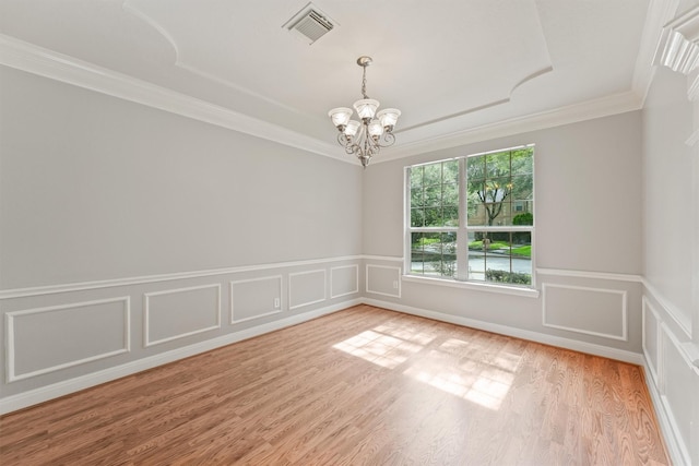 14210 Hansons Creek Ct, Houston, TX 77044 - unfurnished room with a chandelier, ornamental molding, light wood finished floors, wainscoting, and a decorative wall