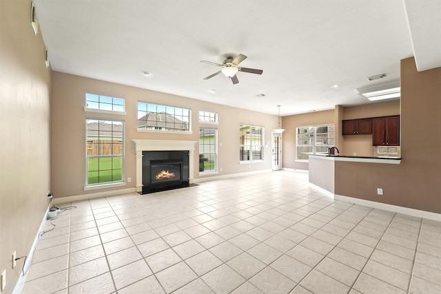 14210 Hansons Creek Ct, Houston, TX 77044 - unfurnished living room with ceiling fan, healthy amount of natural light, a fireplace with flush hearth, light tile patterned floors, and recessed lighting