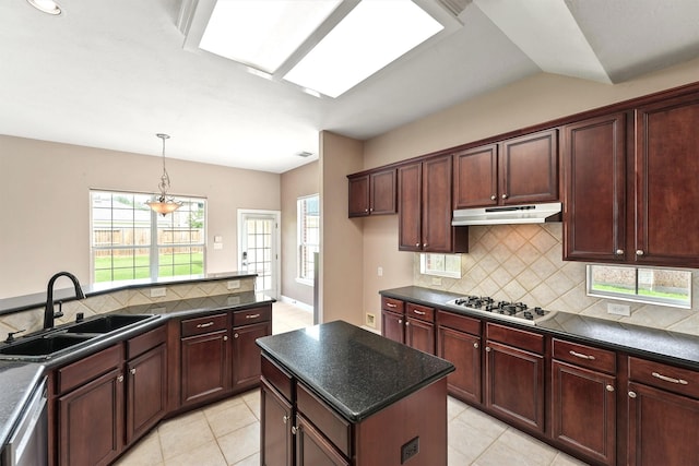 14210 Hansons Creek Ct, Houston, TX 77044 - kitchen featuring gas stovetop, dark countertops, under cabinet range hood, and stainless steel dishwasher