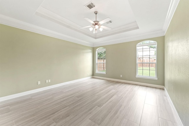 14210 Hansons Creek Ct, Houston, TX 77044 - empty room with a tray ceiling, ornamental molding, ceiling fan, and light wood-type flooring
