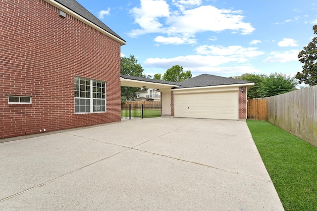 14210 Hansons Creek Ct, Houston, TX 77044 - view of home's exterior with brick siding, driveway, and roof with shingles